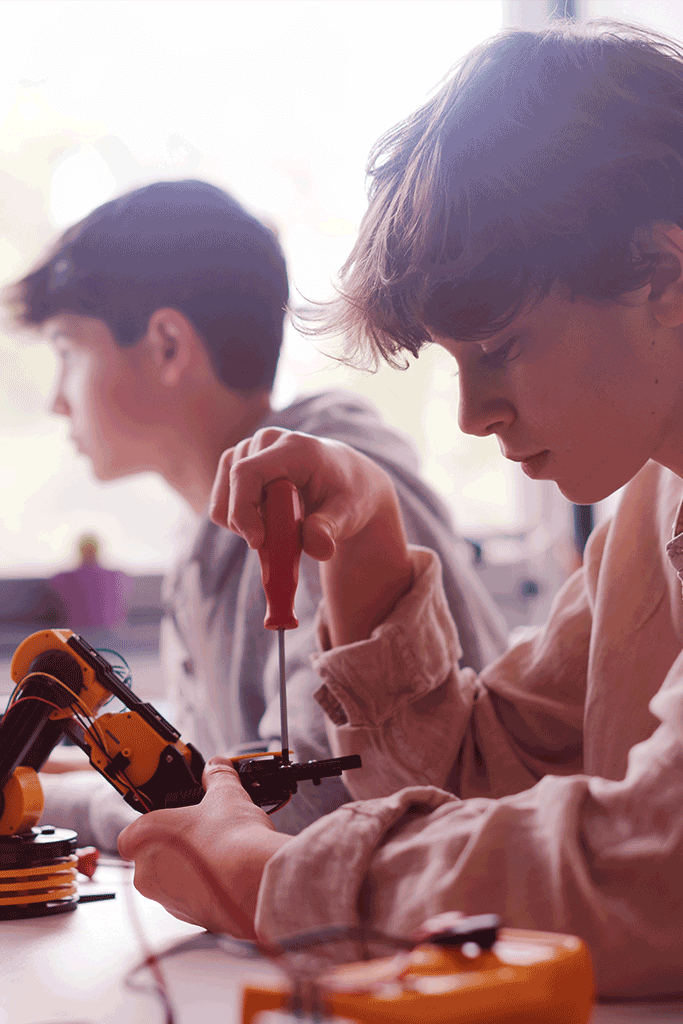 Students working on a robotic arm
