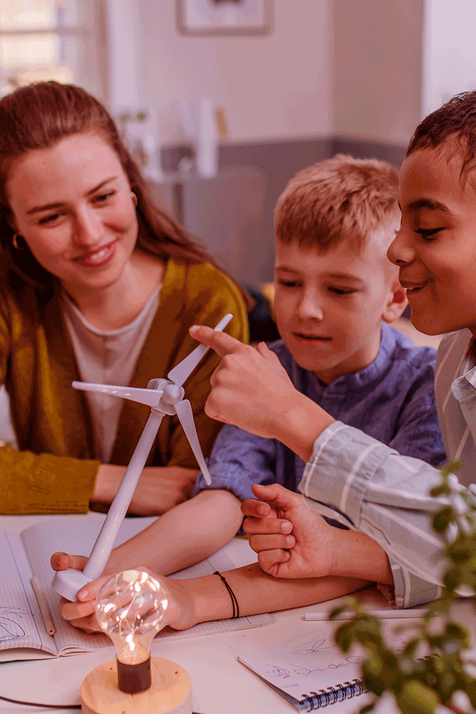 Teacher and students assembling a windmill model